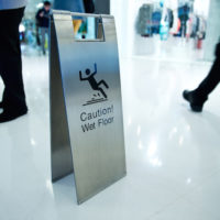 cleaning in progress, and wet floor caution sign besides. cleaning in progress, and wet floor caution sign besides.