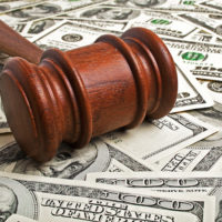 Wooden gavel and American dollars Wooden gavel and American dollars
