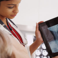 female doctor reviewing x-ray with mature patient female doctor reviewing x-ray with mature patient