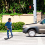 A man is jaywalking across an intersection when the signal is clearly showing the do not cross symbol. A man is jaywalking across an intersection when the signal is clearly showing the do not cross symbol.