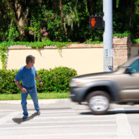 A man is jaywalking across an intersection when the signal is clearly showing the do not cross symbol. A man is jaywalking across an intersection when the signal is clearly showing the do not cross symbol.