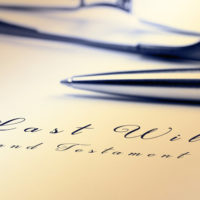 Last will and testament with pen and reading glasses. Last will and testament with pen and reading glasses.