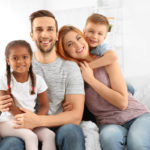 Happy interracial family sitting on sofa Happy interracial family sitting on sofa