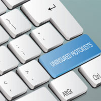 uninsured motorists written on the keyboard button uninsured motorists written on the keyboard button