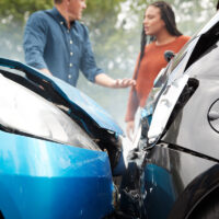 Two Angry Motorists Arguing Over Responsibility For Car Accident Two Angry Motorists Arguing Over Responsibility For Car Accident