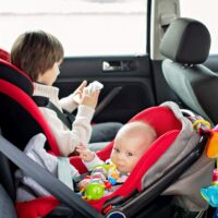 Little baby boy and his older brother, traveling in car seats, going on a holiday Little baby boy and his older brother, traveling in car seats, going on a holiday